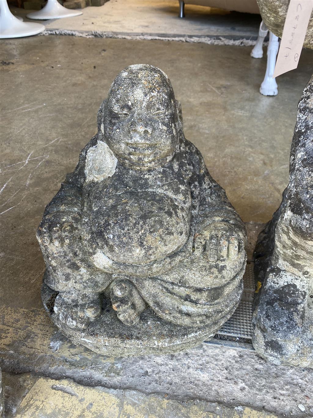 A pair of reconstituted stone garden gnomes, height 62cm together with a seated Buddha